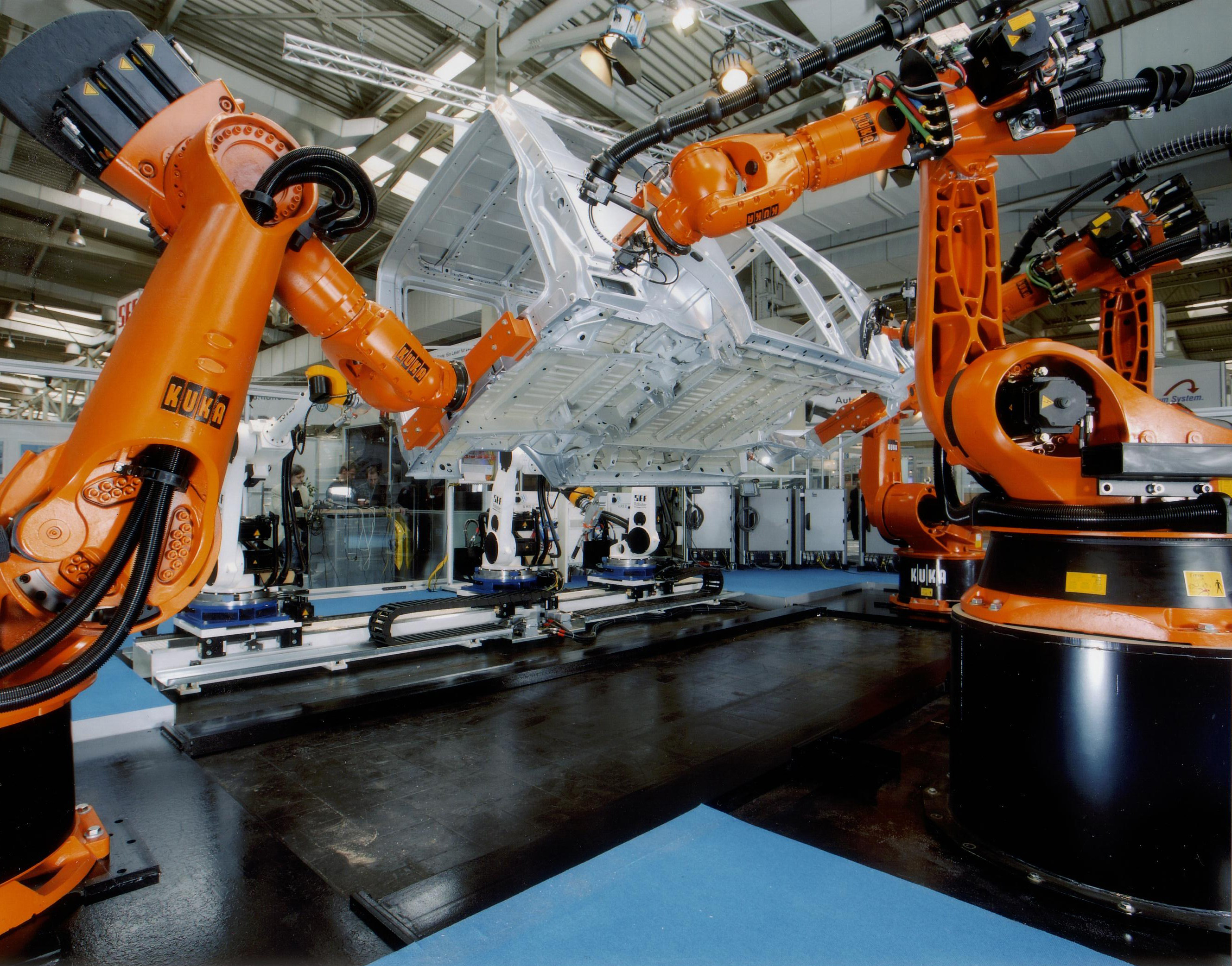 Industrial robotic arms on a manufacturing line